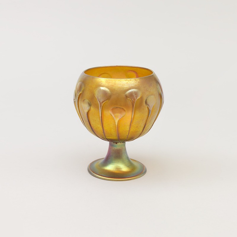 A chalice with patterns along its side.