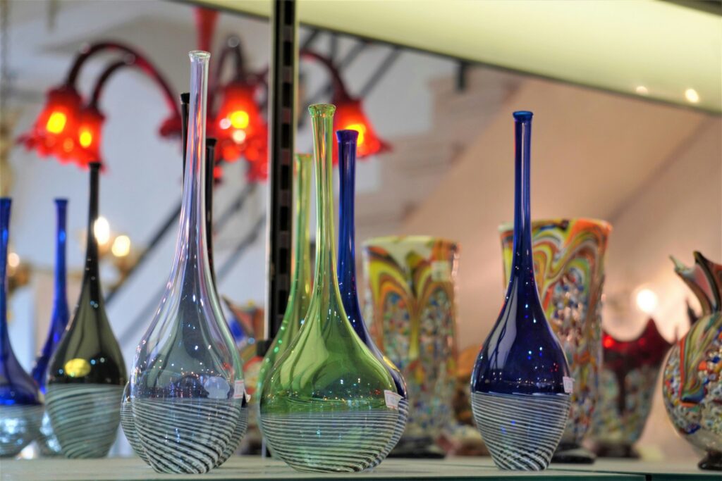 dan hadar lcropps6ax4 unsplash Long slender glass vases sitting on a shelf